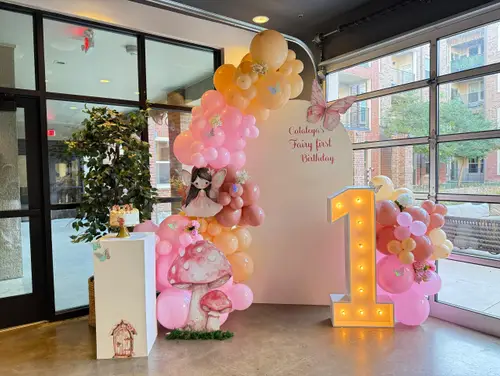 Fairy themed first birthday balloon arch in pink and peach
